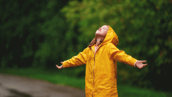 Girl standing in the rain on a rainy day