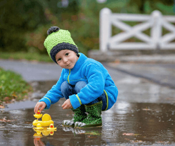 boy playing in puddle